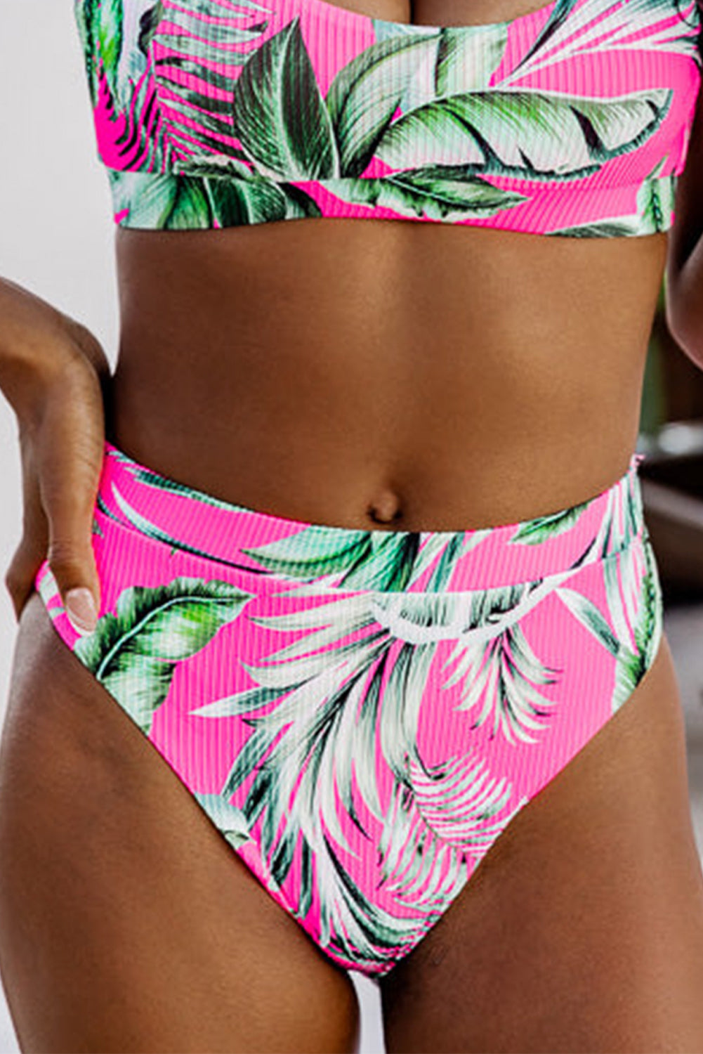 Front view of Rose Tropical Print Textured Bikini Bottoms in pink with green leaf pattern, available at Faith & Co. Boutique for summer swimwear.