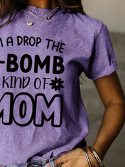 a woman wearing a purple shirt that says i'm a drop the bomb kind
