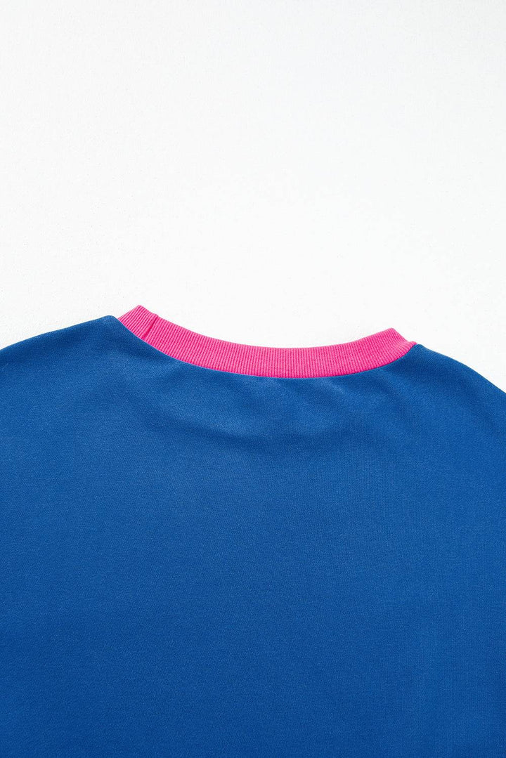 a blue shirt with a pink stripe on the chest