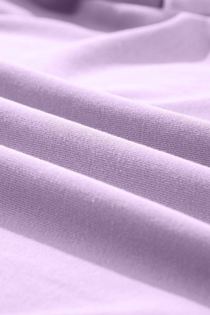 a close up view of a light purple fabric