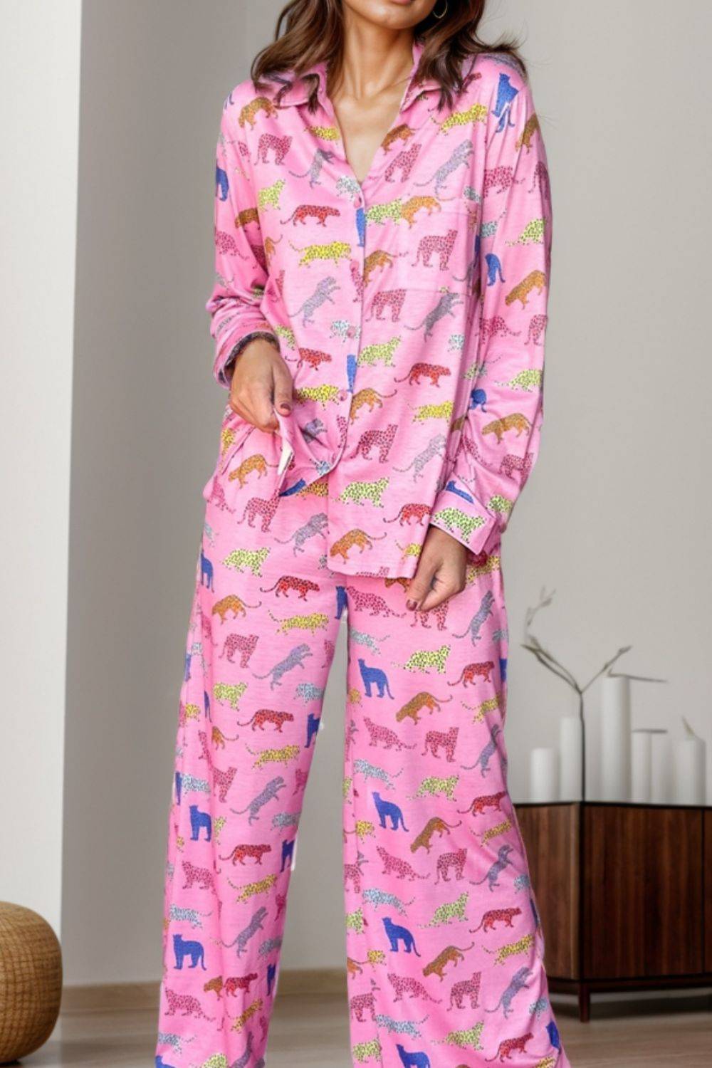 a woman wearing a pink pajamasuit with horses on it