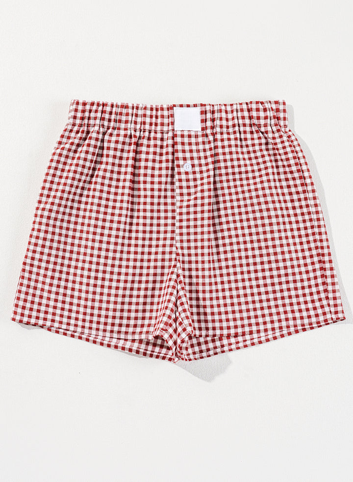 Flat lay of Red Plaid Gingham Printed High Waist Shorts featuring red and white checkered pattern. Lightweight casual shorts available at Faith & Co. Boutique.