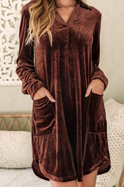 a woman wearing a brown velvet dress