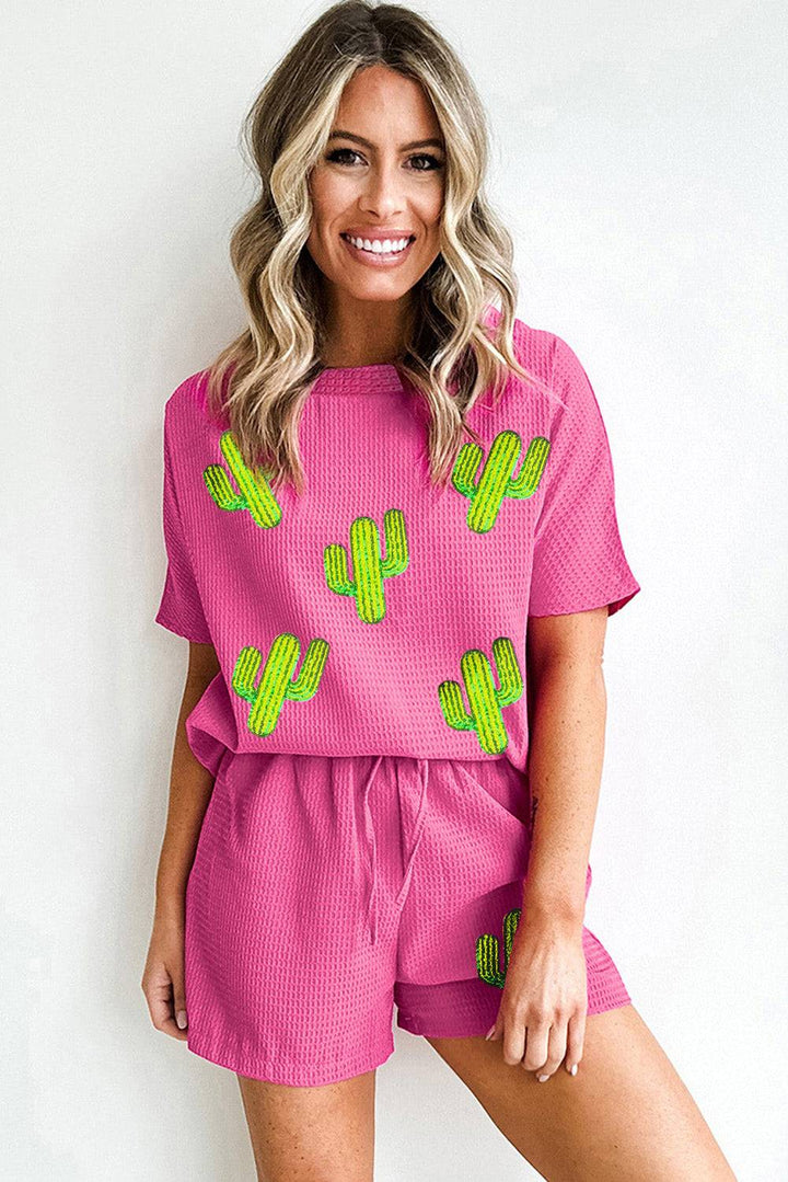 a woman in a pink outfit with a cactus on it