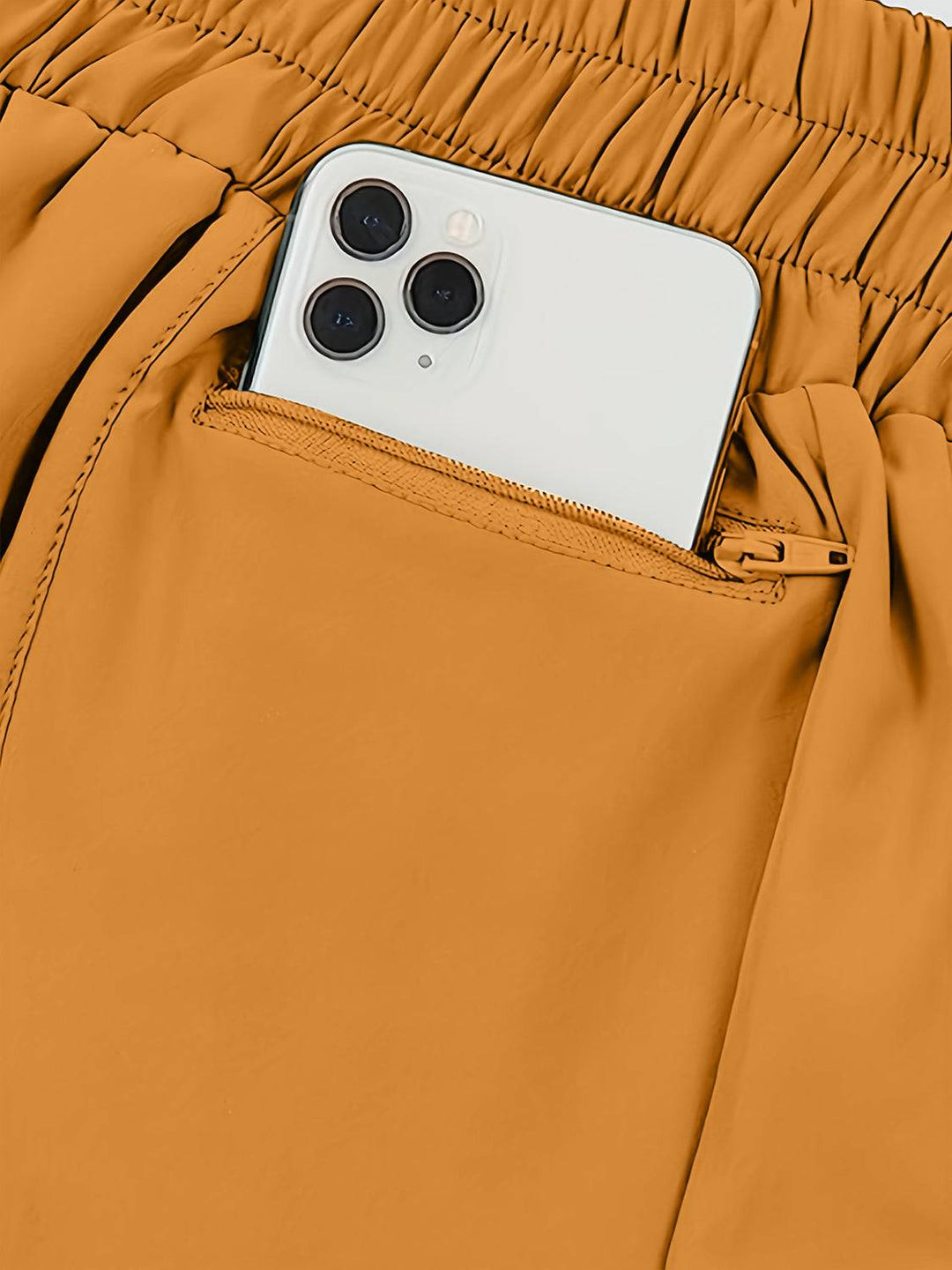 a cell phone sticking out of the pocket of a pair of pants