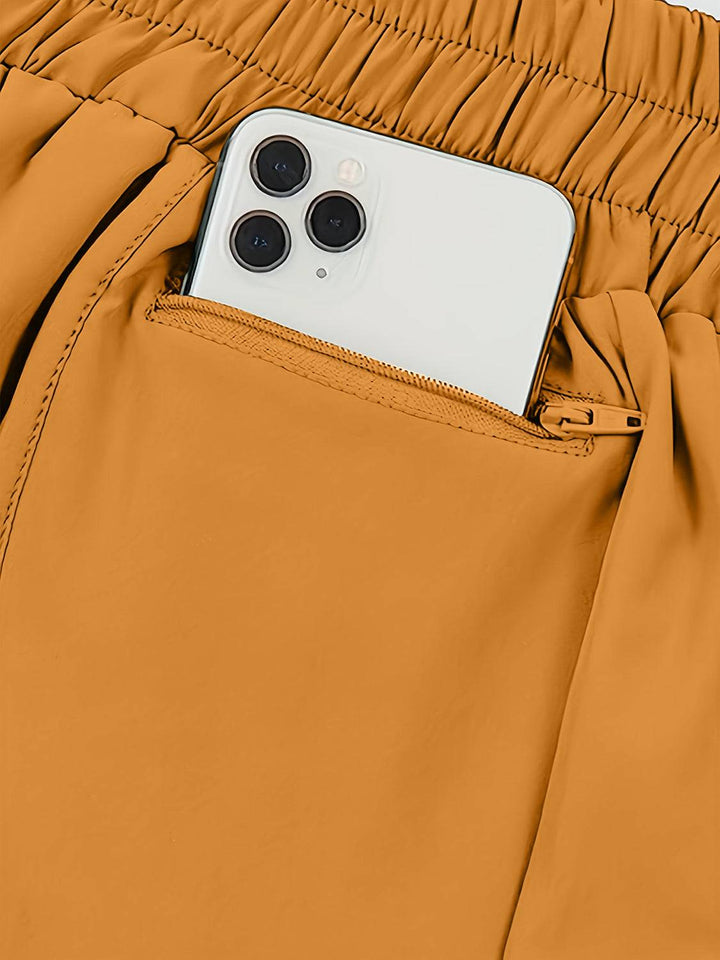 a cell phone sticking out of the pocket of a pair of pants