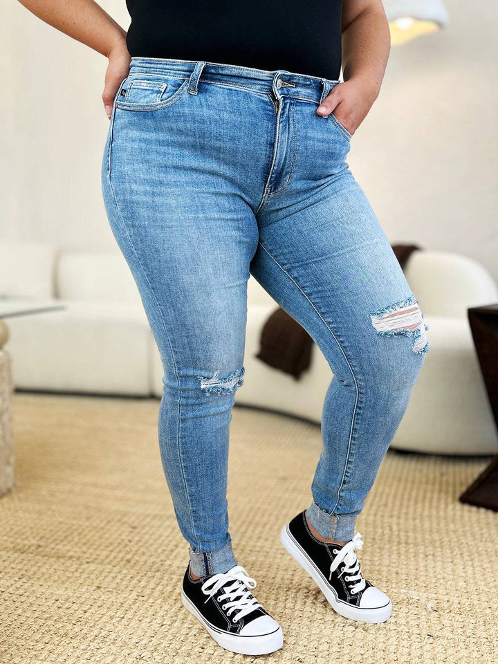 a woman in black shirt and jeans standing in a room