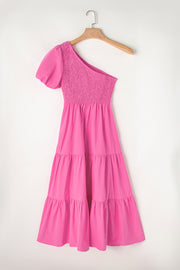 a pink dress hanging on a wooden hanger