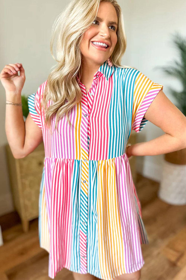 a woman wearing a colorful striped shirt dress