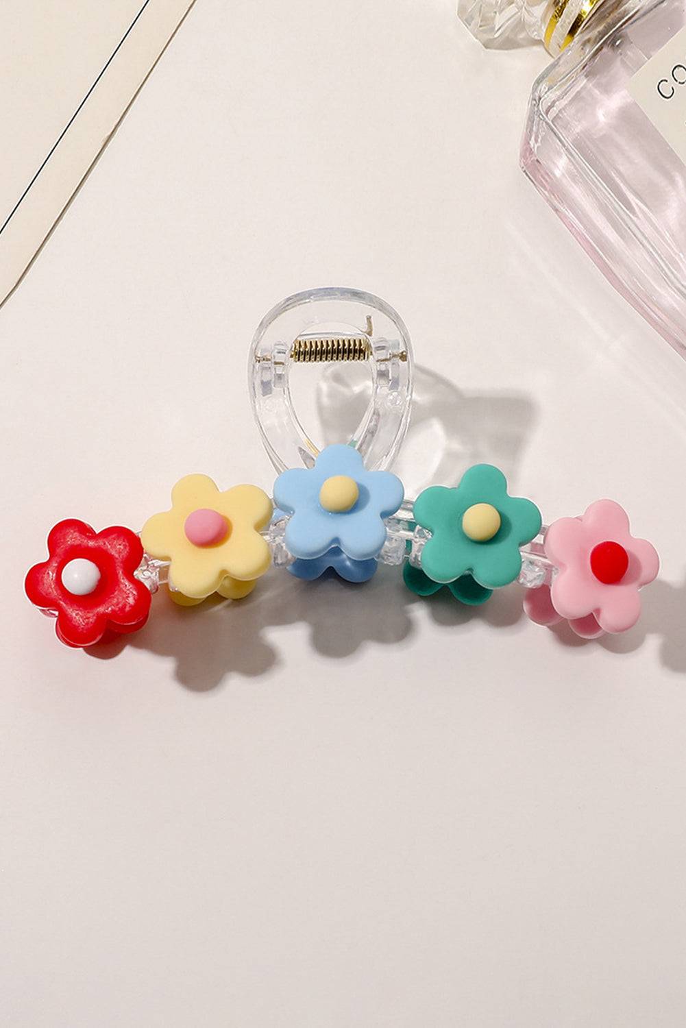 a group of four flower shaped beads sitting on top of a table