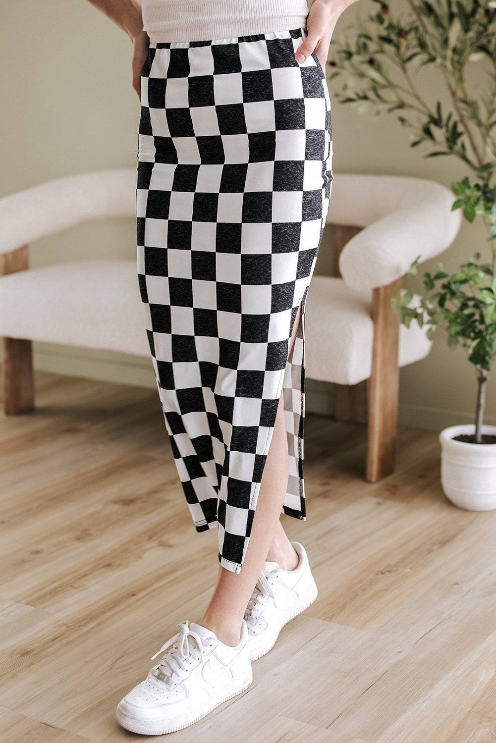Back view of White Checkered Print Midi Skirt styled indoors, showcasing the bold plaid print and flattering silhouette.