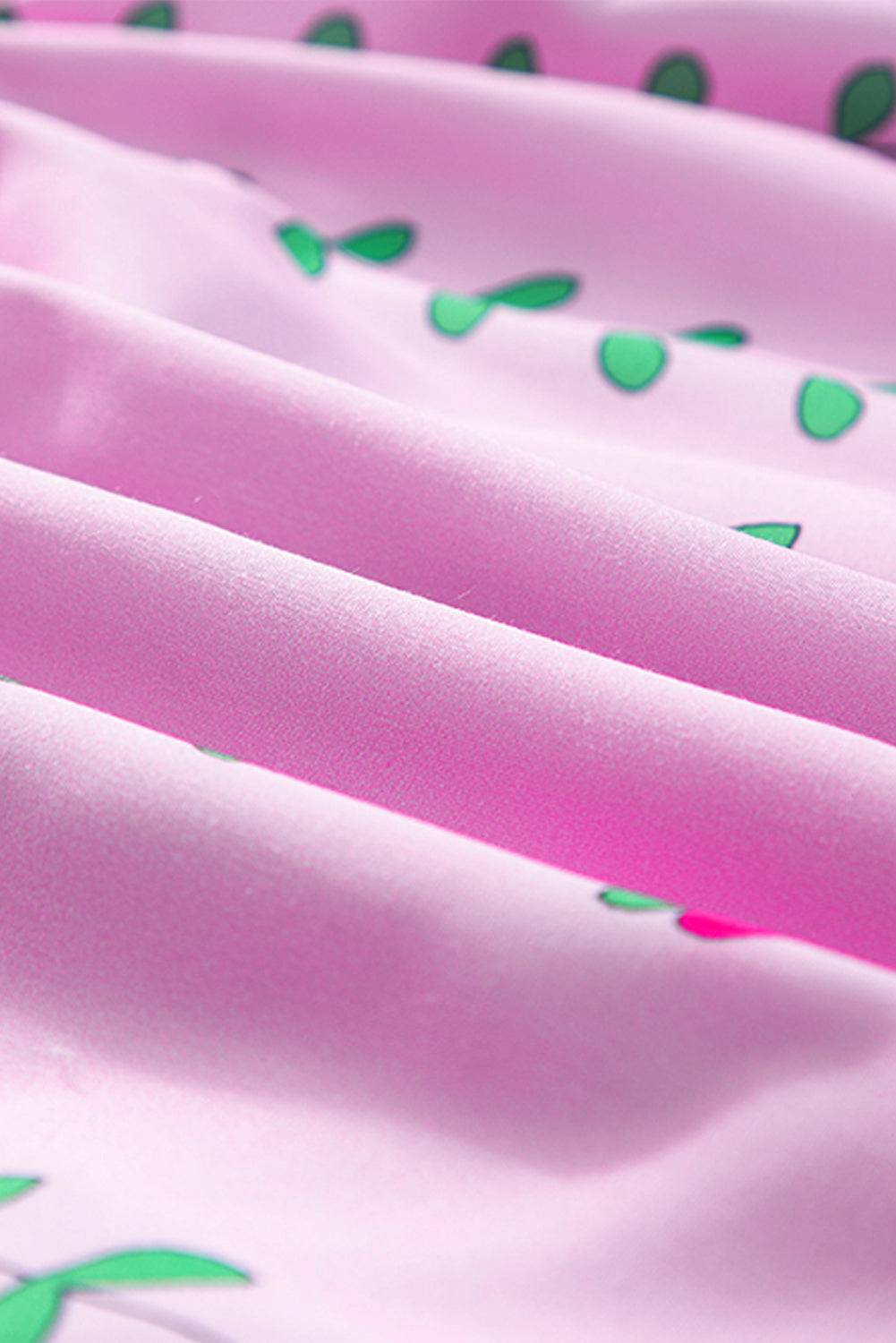 a close up of a pink and green fabric