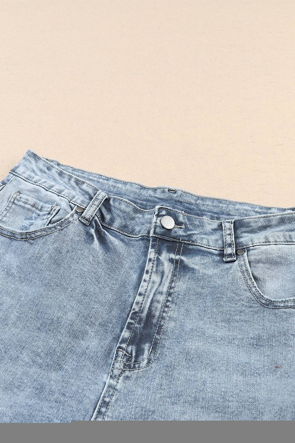 a pair of jeans with a button on the side