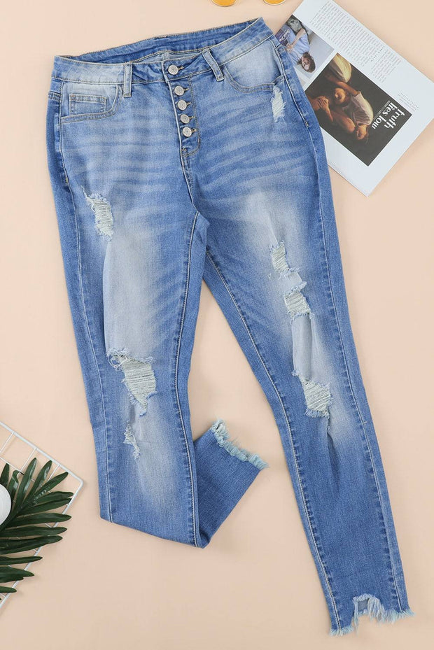 a pair of ripped jeans next to a magazine