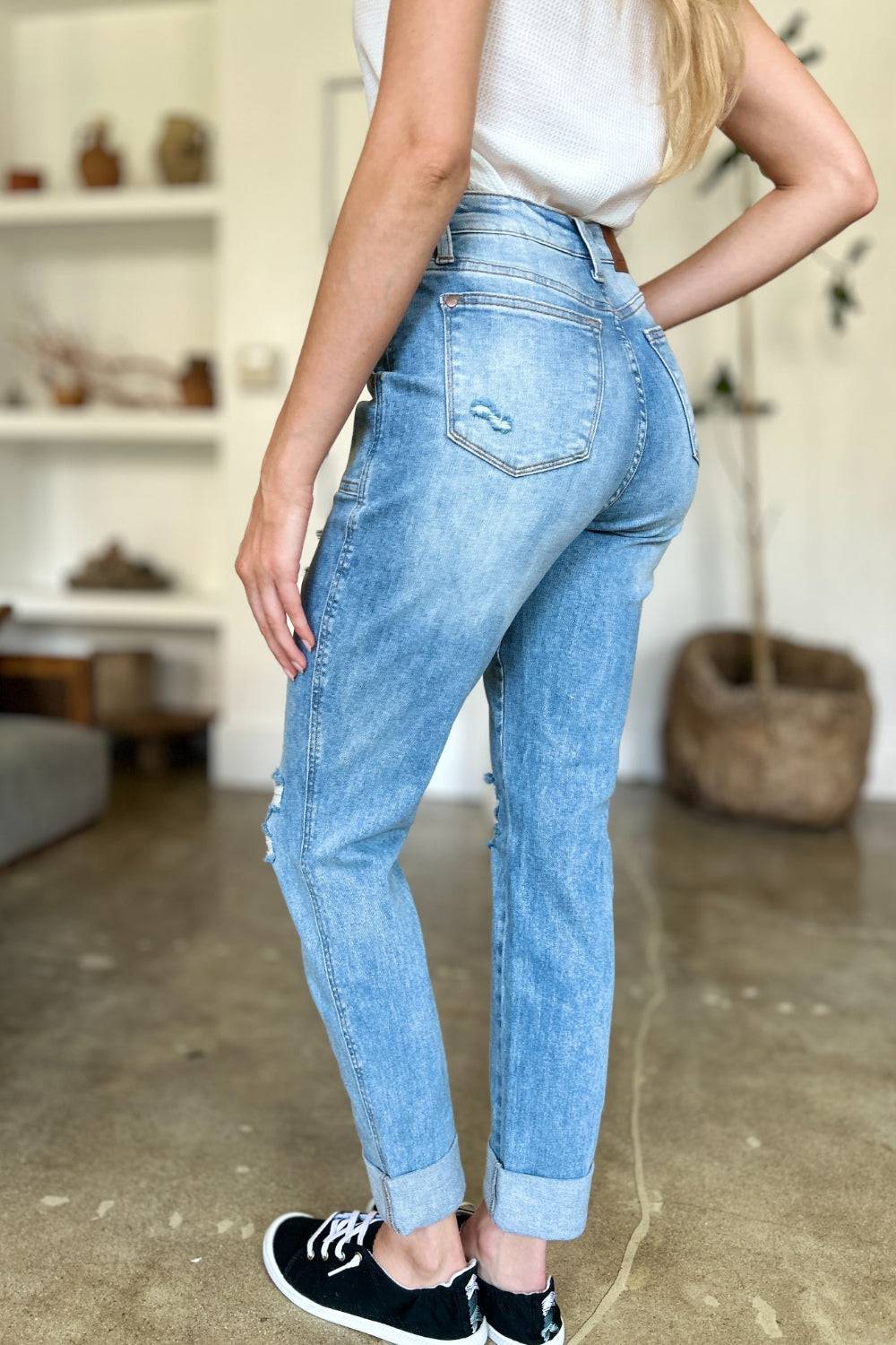 a woman standing in a room with her hands on her hips