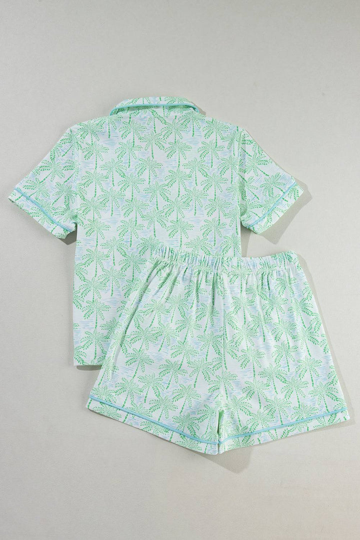 a baby boy's pajamas with a green leaf print