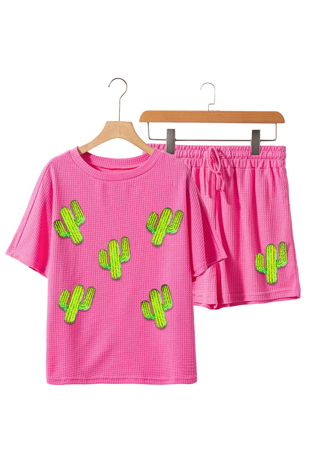 a pink shirt and shorts with green cactus designs