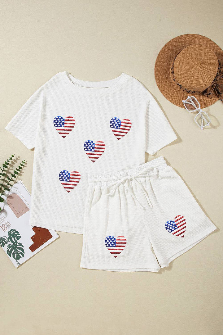 a t - shirt and shorts with american flags on them