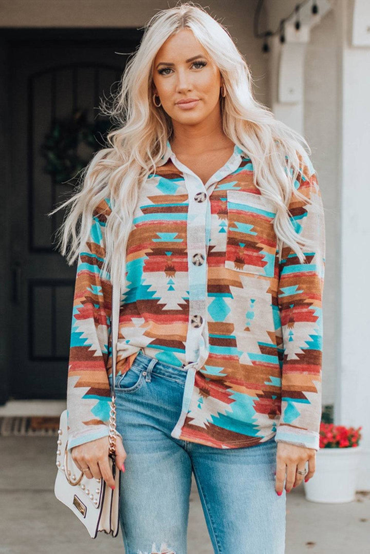 a woman wearing a colorful sweater and ripped jeans