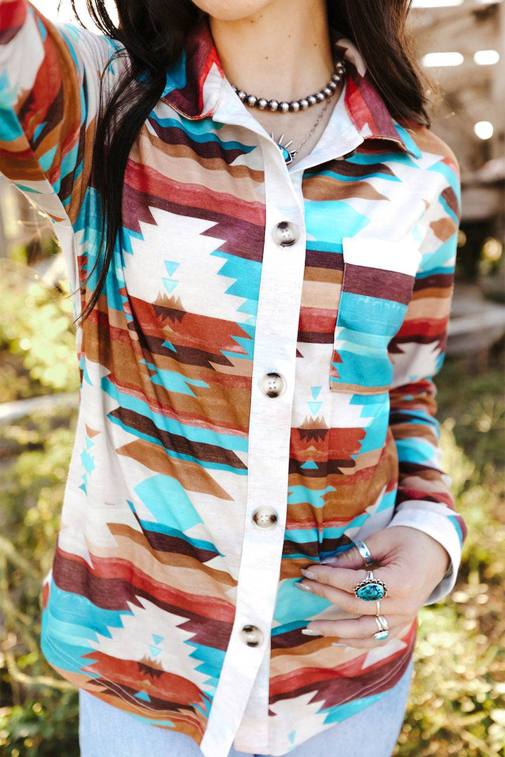 a woman wearing a hat and a colorful shirt