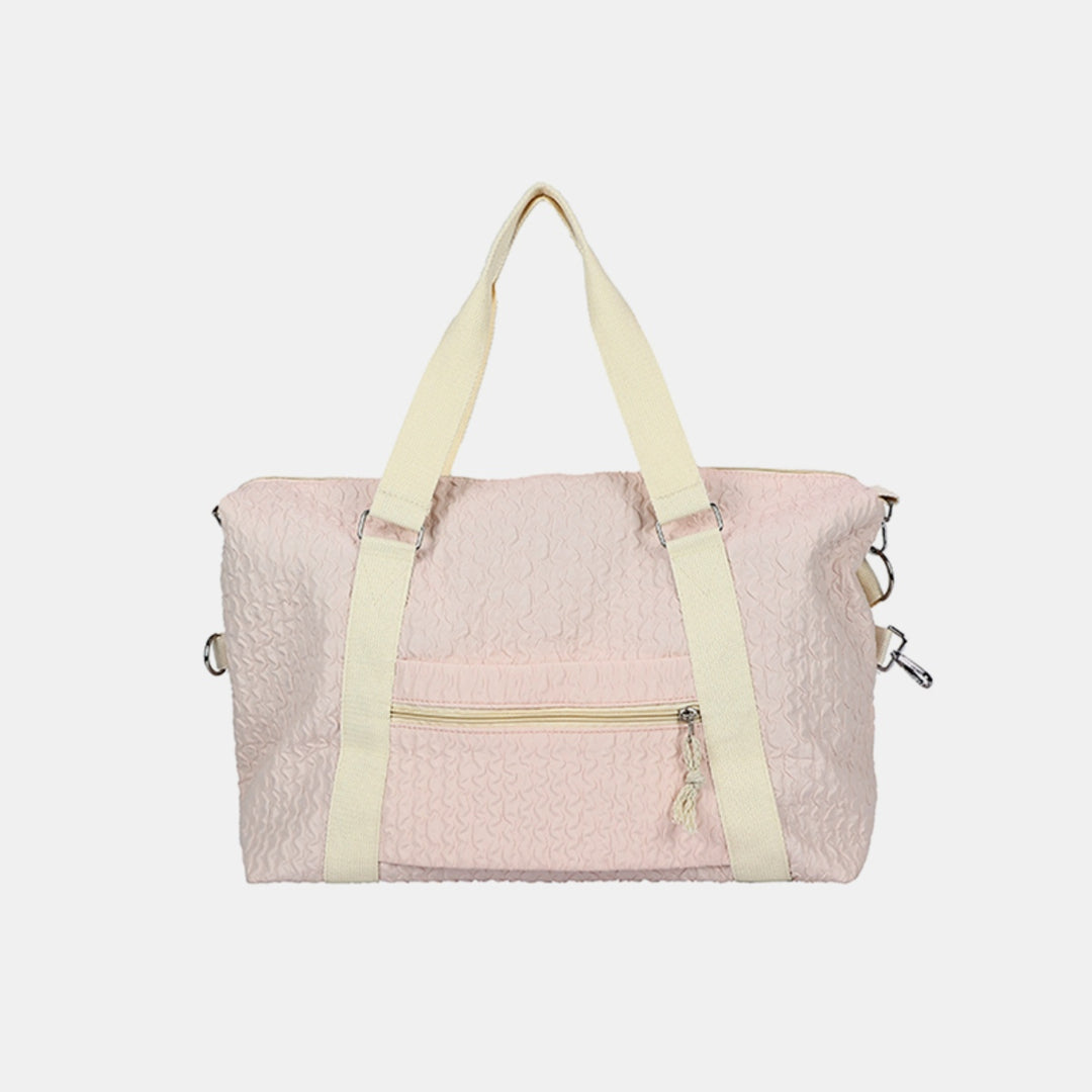 a pink and white bag with a yellow strap