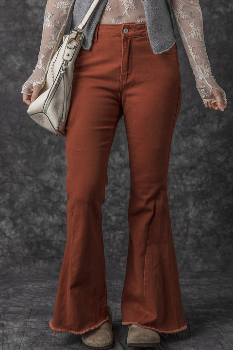 a woman in a white top and brown pants