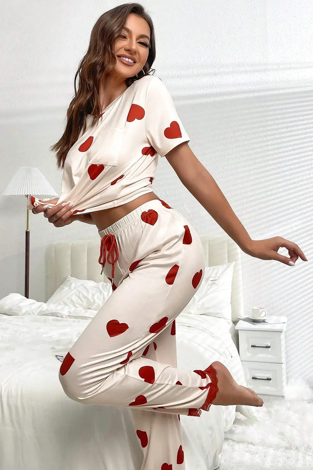 a woman in a white top and red hearts pants