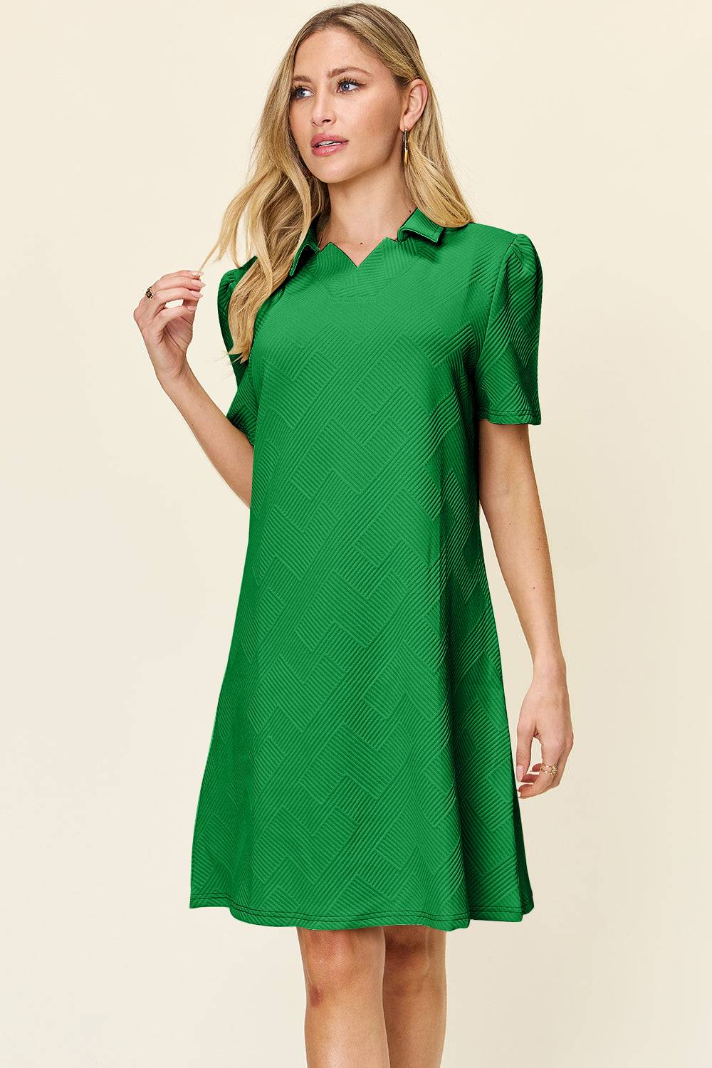 a woman in a green dress posing for a picture