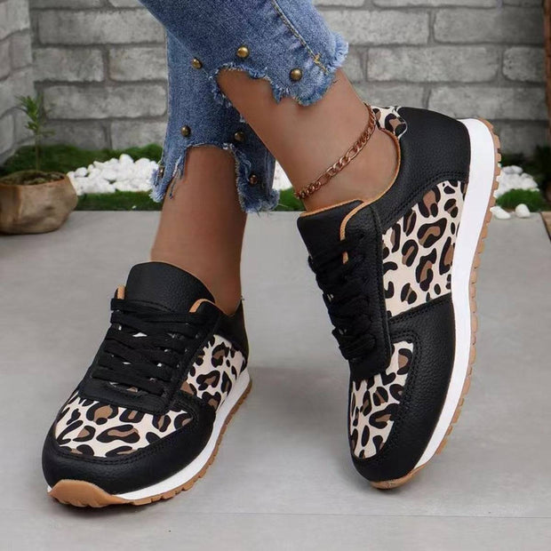 a woman wearing leopard print sneakers