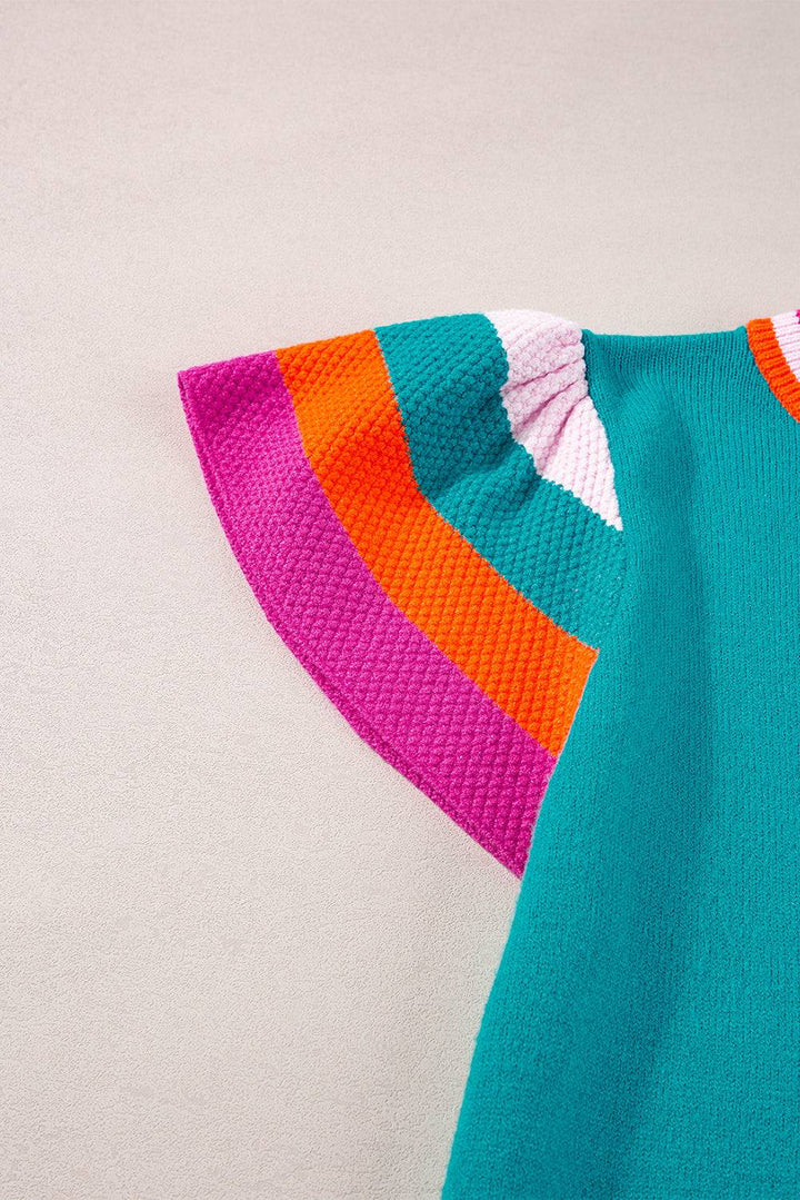 a blue sweater with a pink, orange, and green stripe on it