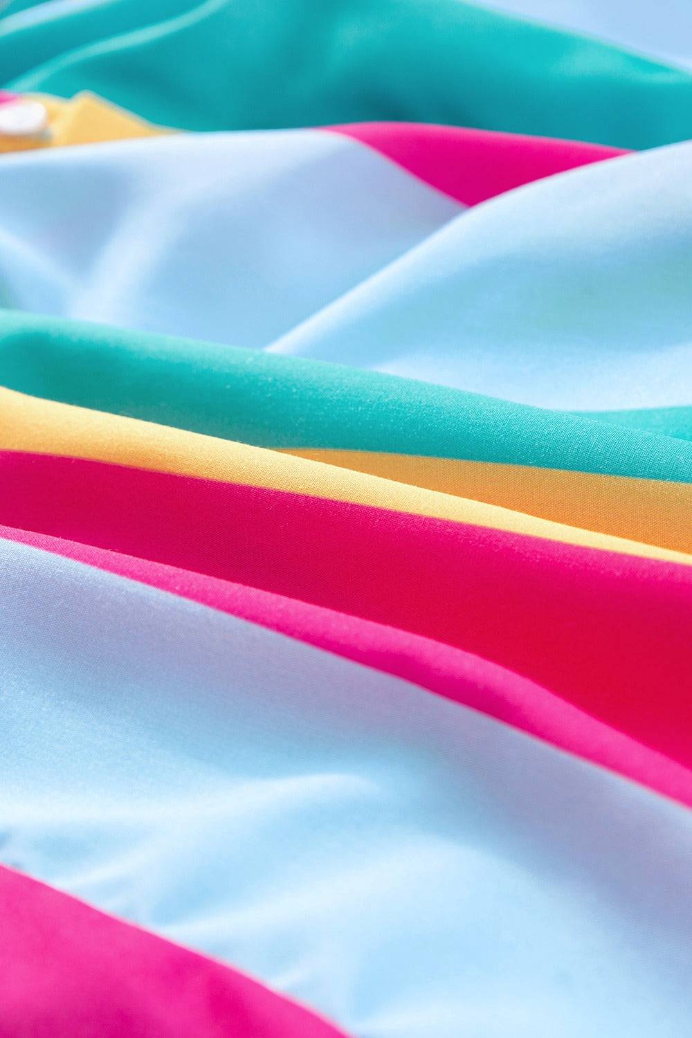 a close up of a multicolored sheet with a toothbrush in it