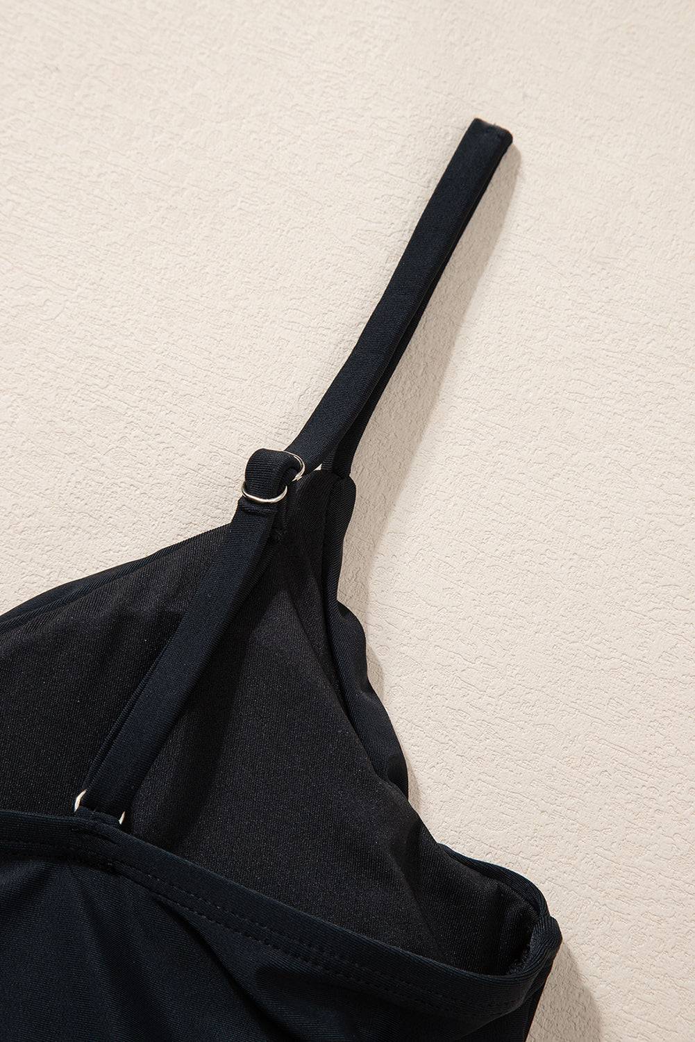 a black bag hanging up against a wall