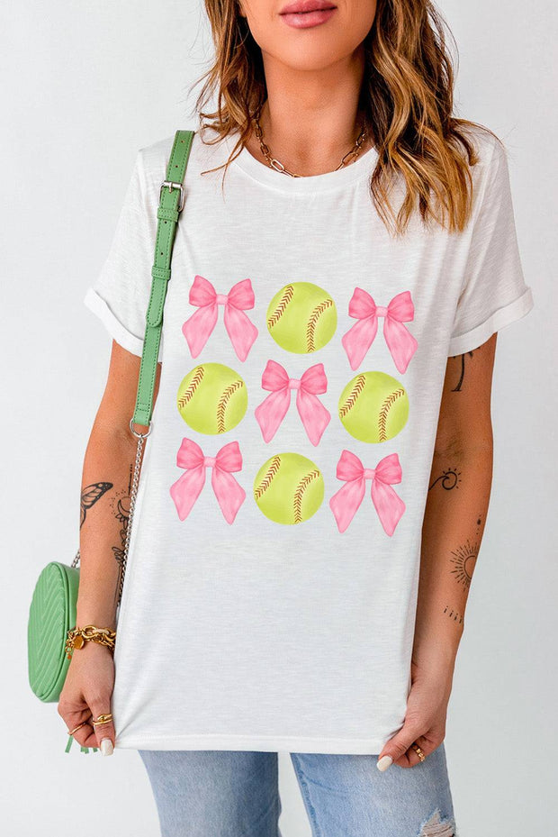 a woman wearing a t - shirt with bows and softballs on it