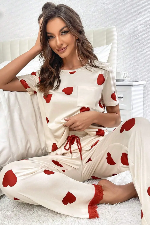 a woman sitting on top of a bed wearing pajamas