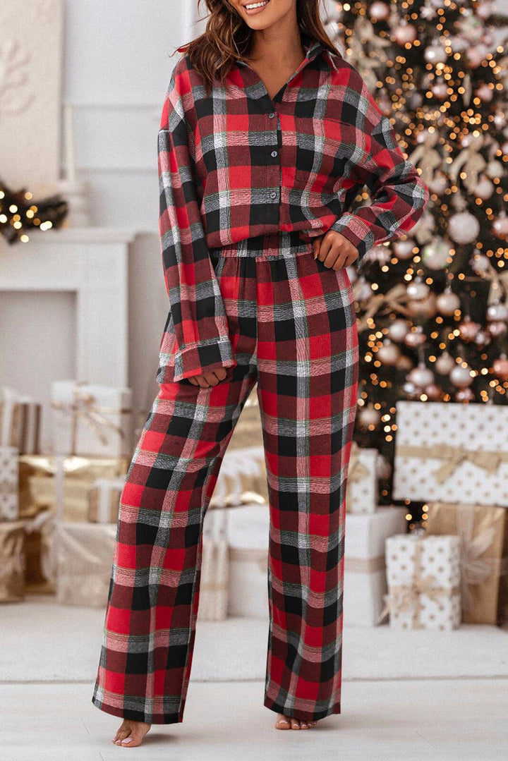 a woman standing in front of a christmas tree