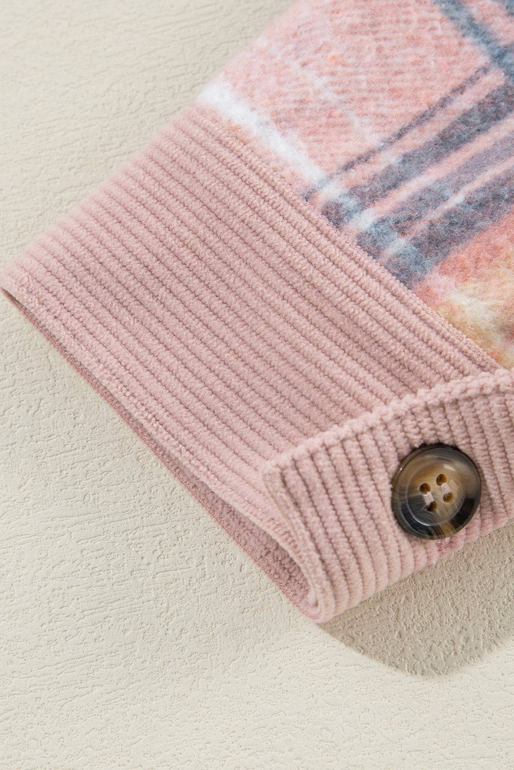 a pink sweater with a button down the middle