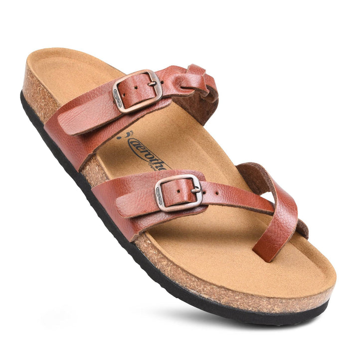 a pair of brown sandals on a white background