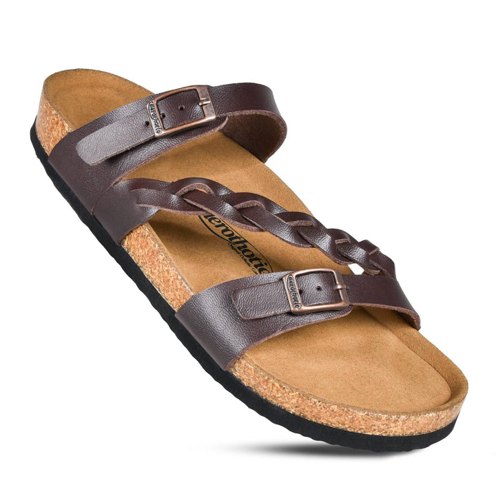 a pair of brown sandals on a white background