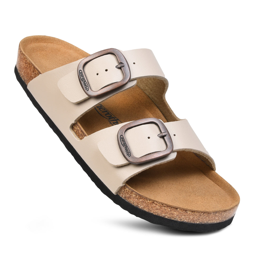 a pair of white sandals with two buckles