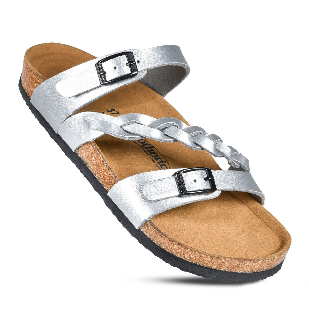 a pair of silver sandals on a white background