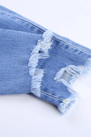 a pair of ripped jeans on a white surface