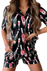 a woman in a black and pink pajamas holding a glass of wine
