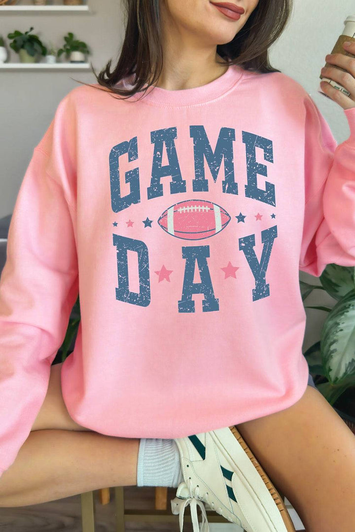 a woman wearing a pink game day sweatshirt