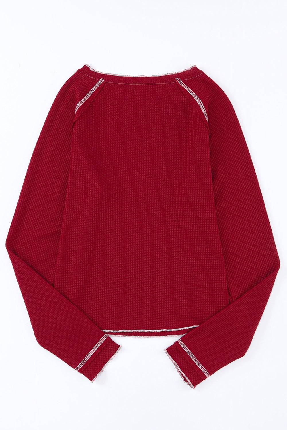 a red sweater with white piping on the shoulders