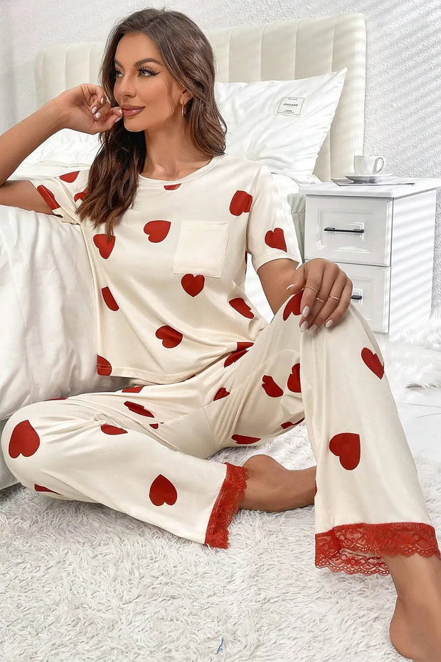 a woman sitting on top of a bed wearing pajamas