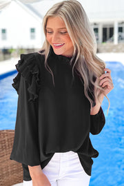 a woman standing next to a pool wearing a black top