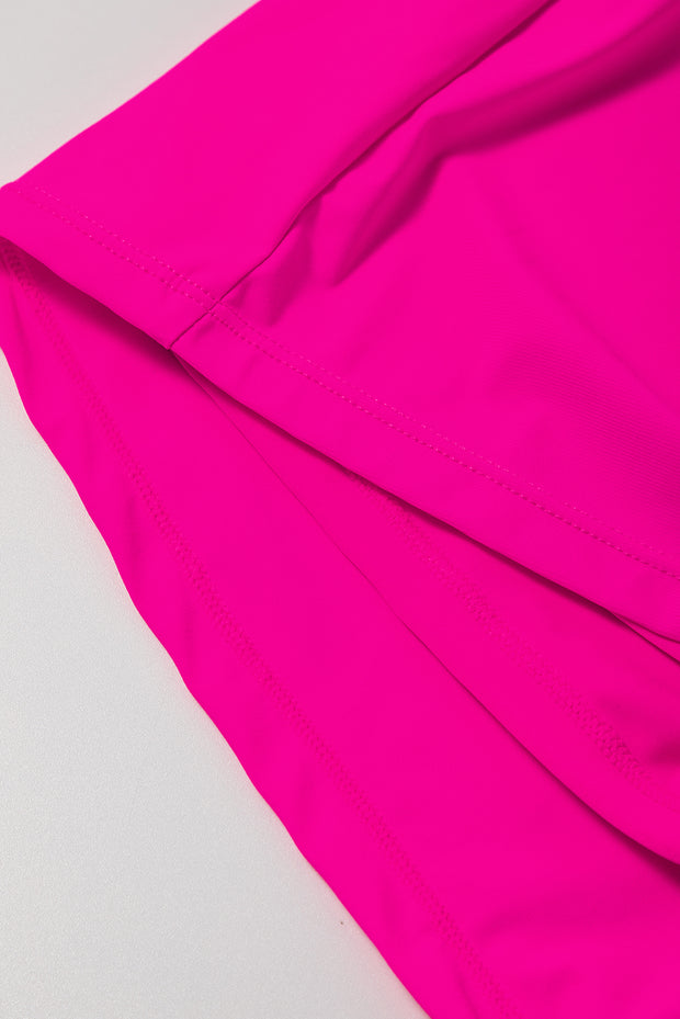 a close up of a pink skirt on a white surface