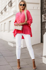 a woman wearing white pants and a pink blouse