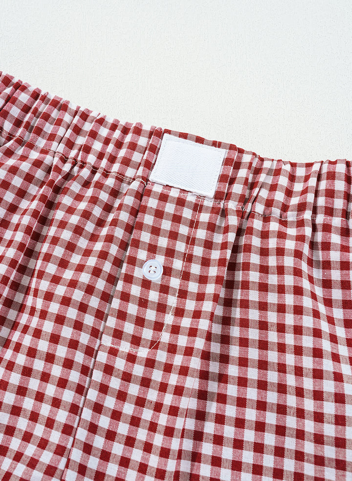 Detailed view of waistband and button closure on Red Plaid Gingham Printed High Waist Shorts. Shop stylish plaid summer shorts at Faith & Co. Boutique.