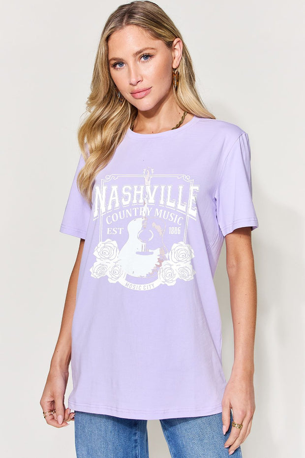 a woman wearing a purple nashville t - shirt